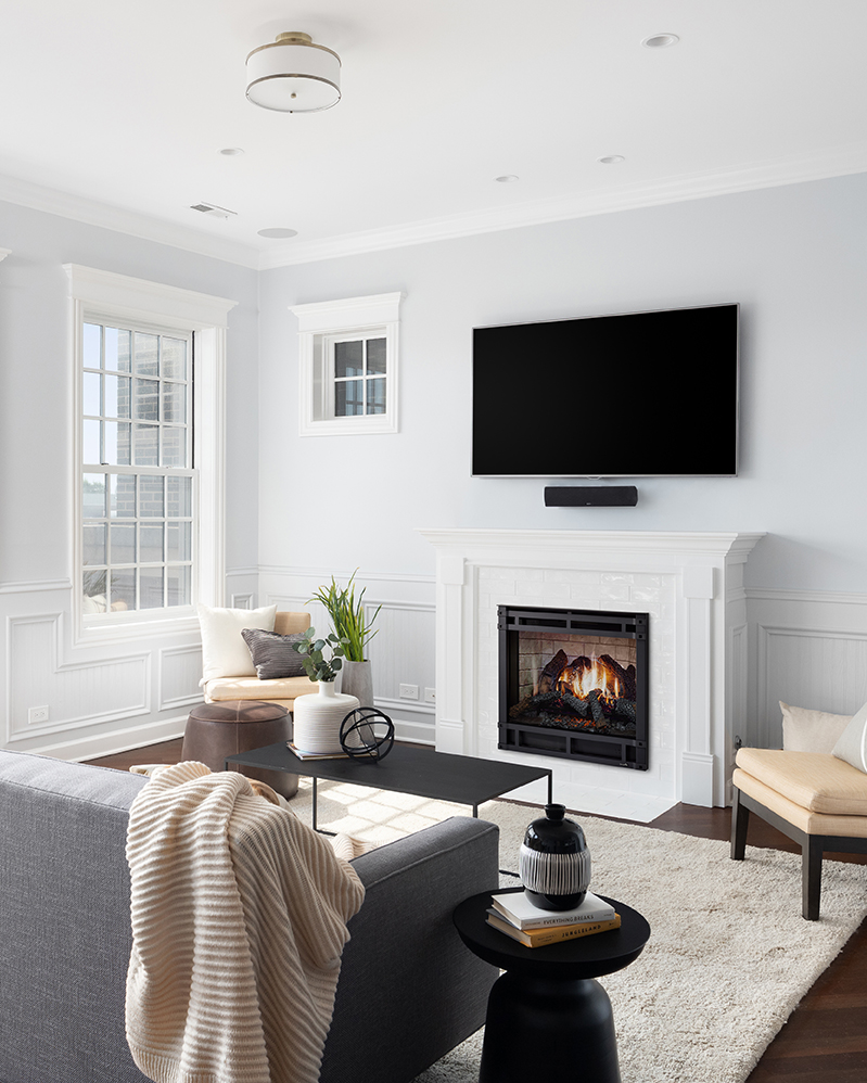 A cozy living room with seating set around a mounted television